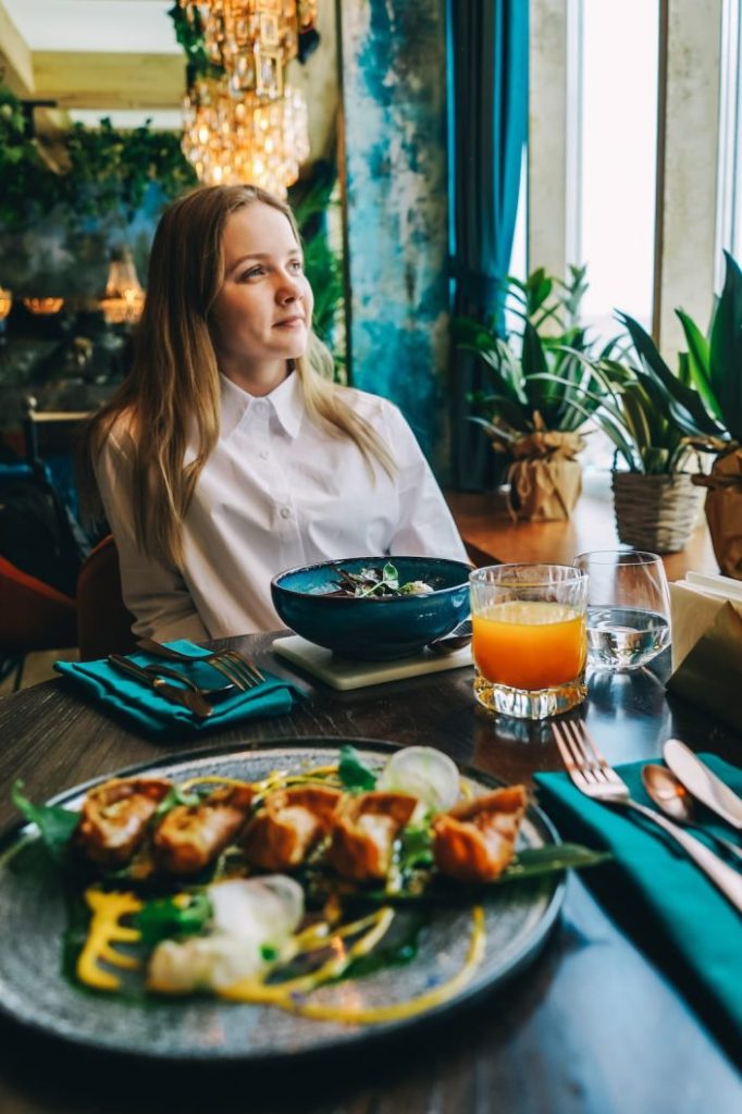 young-beautiful-woman-have-dinner-in-cafe-2023-11-27-04-49-08-utc-705x1058